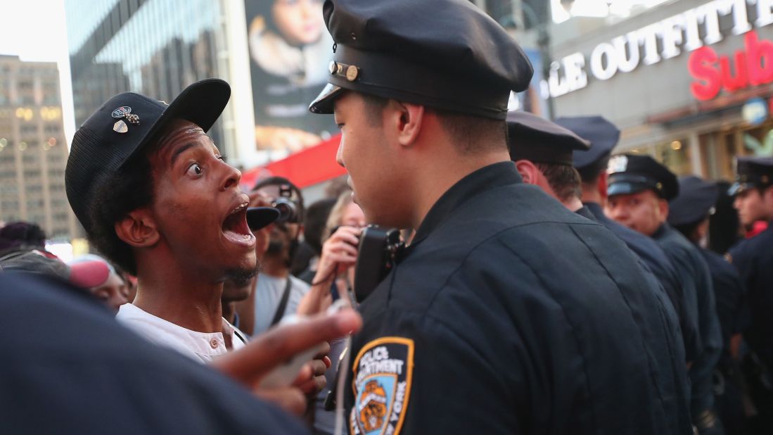 A man argues with a police officer as supporters of Trayvon Martin march while blocking traffic in Union Square in New York on Sunday, July 14.