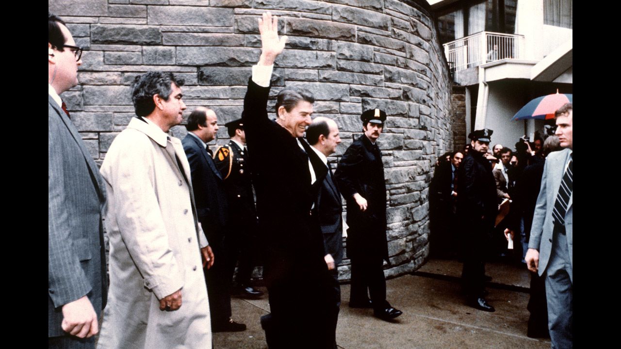 On March 30, 1981, six shots were fired at President Ronald Reagan outside the Hilton Hotel in Washington. The shooter, John Hinckley, was taken to the ground immediately.  This photo taken by presidential photographer Mike Evens captures Reagan waving to the crowd moments before the attempted assassination.  