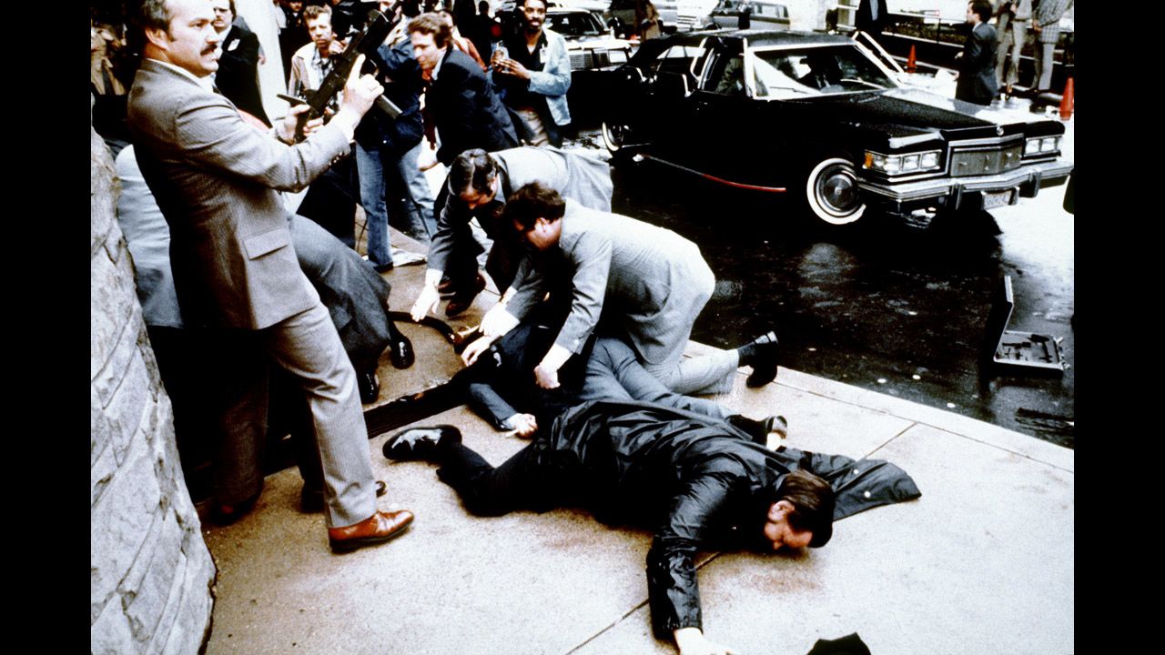 On March 30, 1981, John Hinckley fired six shots at Reagan as he exited a Washington hotel with his entourage. Police officer Thomas Delahanty (foreground) and Press Secretary James Brady (behind) lay wounded on the ground. Reagan was hit by one of the bullets and was hospitalized for 12 days. He fully recovered. 