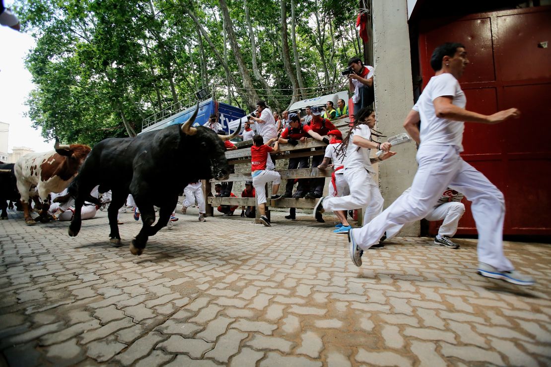 Thrill seekers race amid Miura's bulls during the last bull run of the San Fermin Festival in Pamplona, Spain, on Sunday.