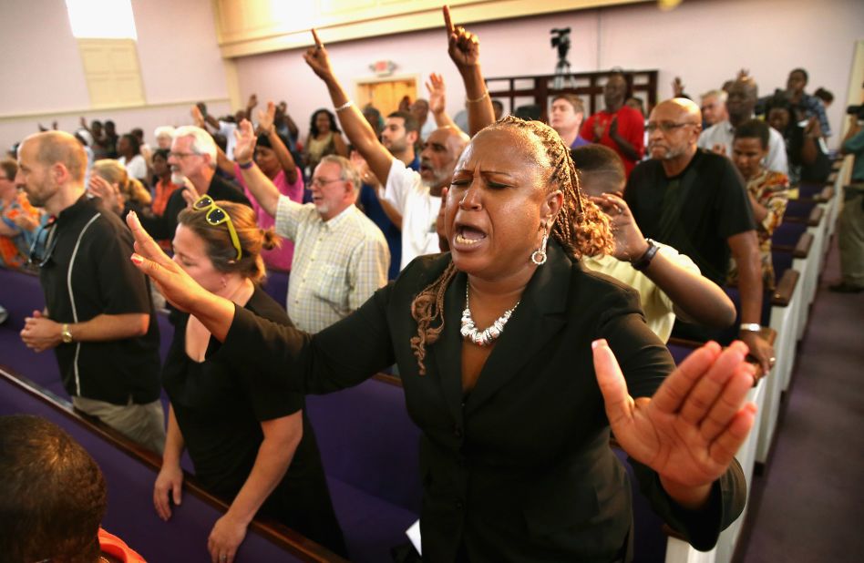 Residents of Sanford, Florida, attend a prayer vigil to promote peace and unity in their city in the wake of the George Zimmerman trial on July 15.