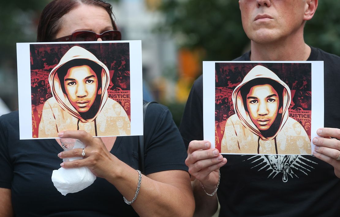 People hold photos of Trayvon Martin at a rally honoring the teenager on July 14, 2013, in New York after George Zimmerman's acquittal.