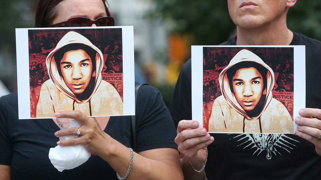 People hold photos of Trayvon Martin at a rally honoring the teenager on July 14, 2013, in New York after George Zimmerman's acquittal.