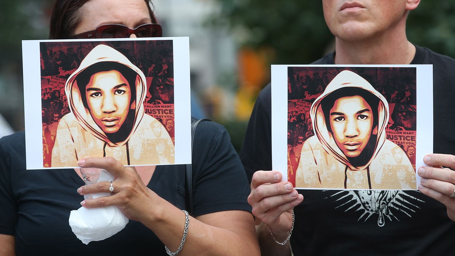 People hold photos of Trayvon Martin at a rally in Manhattan's Union Square on July 14. 
