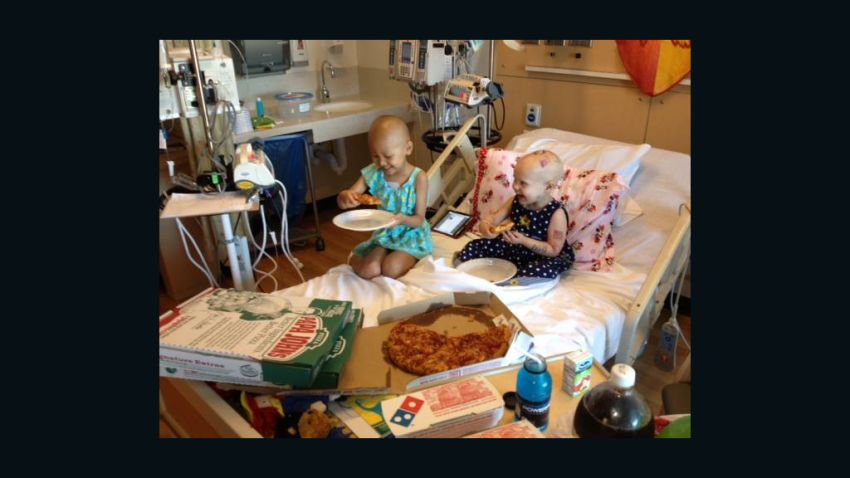 Cancer patient Hazel Hammersley, right, and a friend enjoy pizza at a Los Angeles hospital.