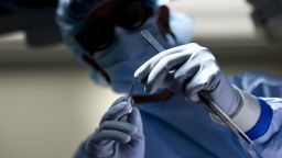 Dr. Niraj Desai orients a suture while he sews in a kidney to a recipient patient during a kidney transplant at Johns Hopkins Hospital June 26, 2012 in Baltimore, Maryland.