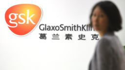 An employee of British drug firm GlaxoSmithKline (GSK) enters their office headquarters in Shanghai on July 1, 2013.
