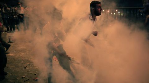 Morsy supporters run from tear gas in Cairo on July 15.