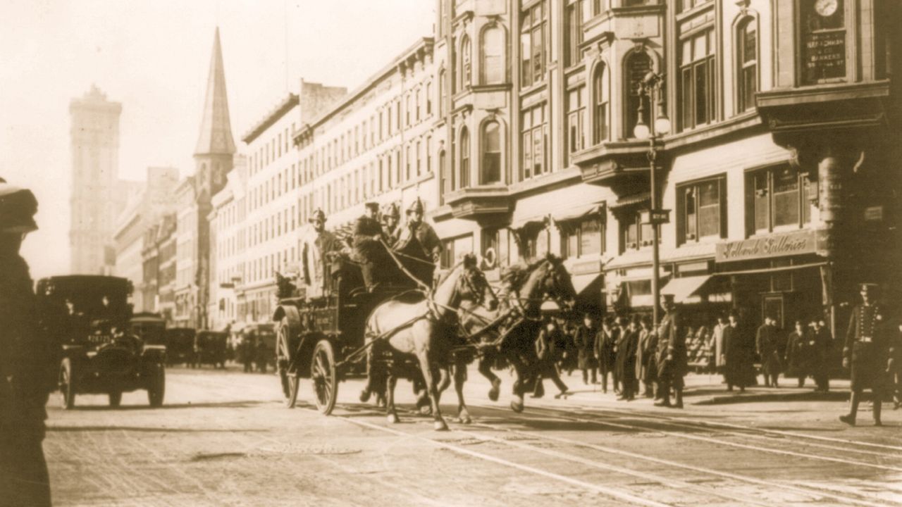 Horse-drawn fire engines rush to the Triangle Shirtwaist Factory fire in March of 1911. 