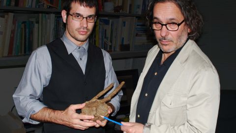Robert DePalma, left, and David Burnham on right, show  the Tyrannosaurus rex tooth.