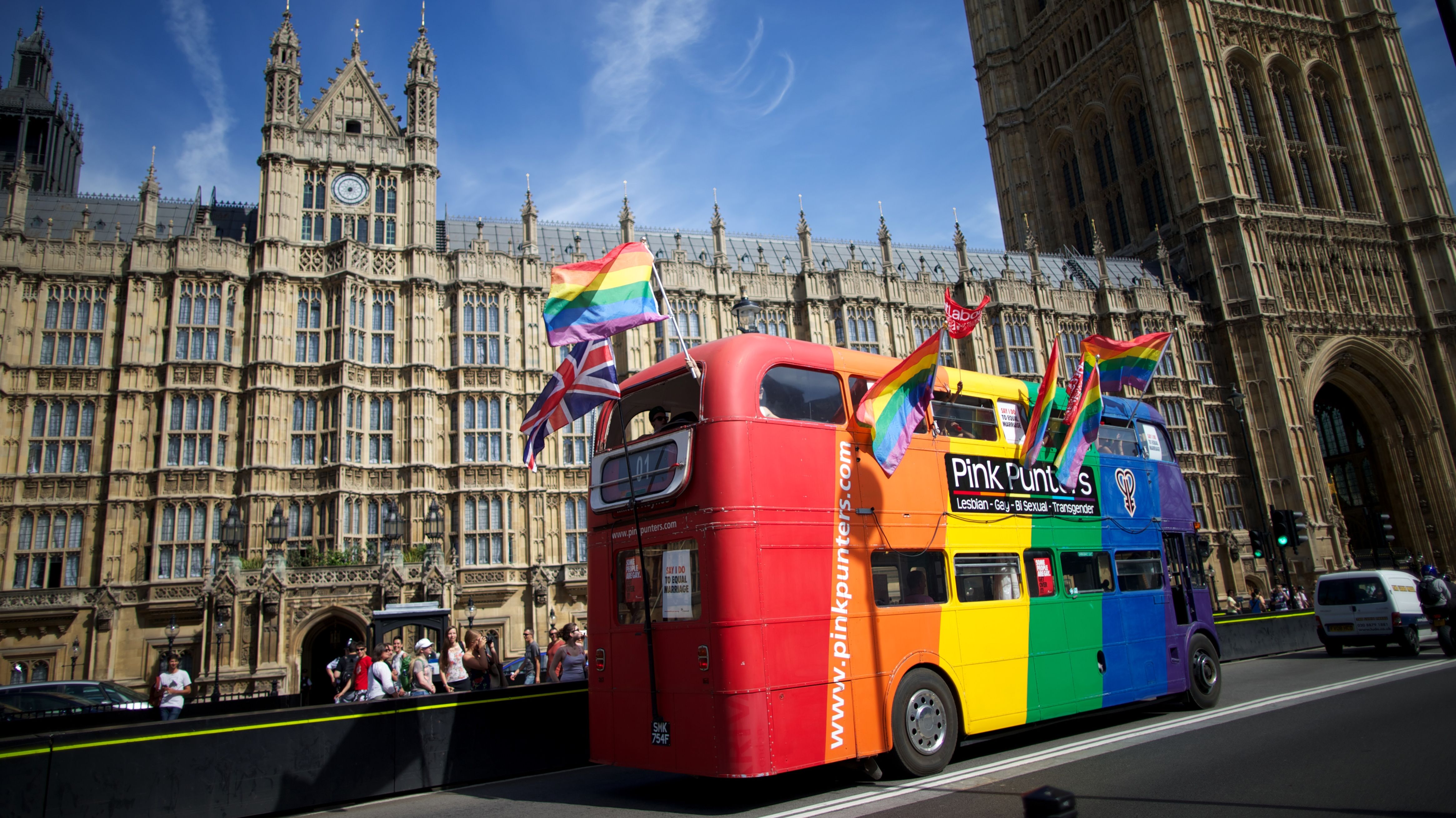 Same-sex marriage campaigners drive a bus past the Houses of Parliament on Monday.