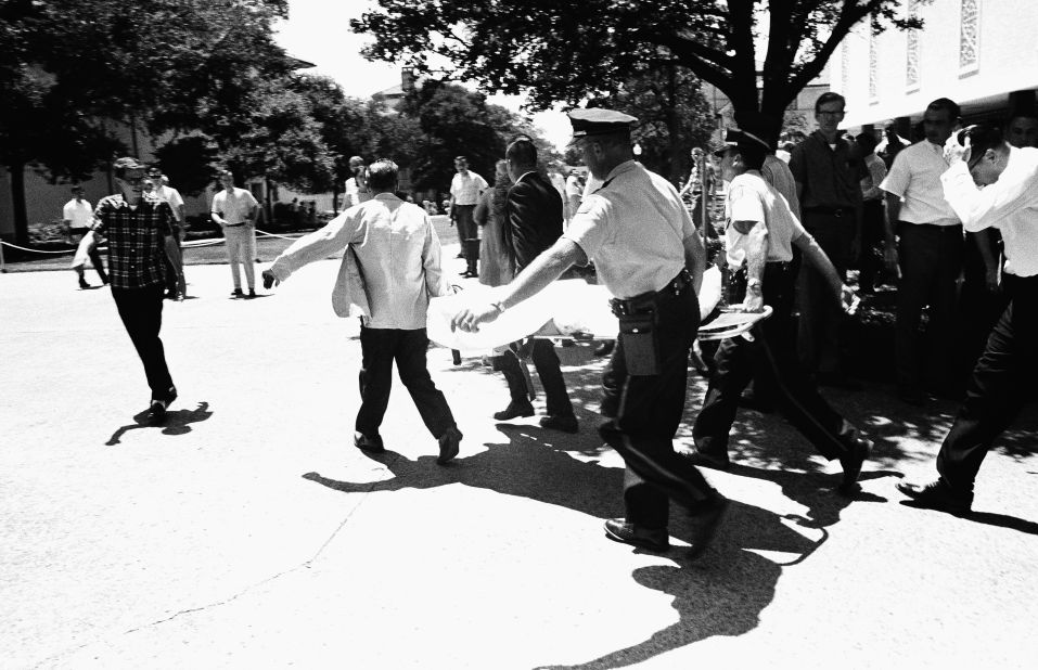 Officers in Austin, Texas, carry victims across the University of Texas campus after Charles Joseph Whitman opened fire from the school's tower, killing 16 people and wounding 30 in 1966. Police officers shot and killed Whitman, who had killed his mother and wife earlier in the day. 