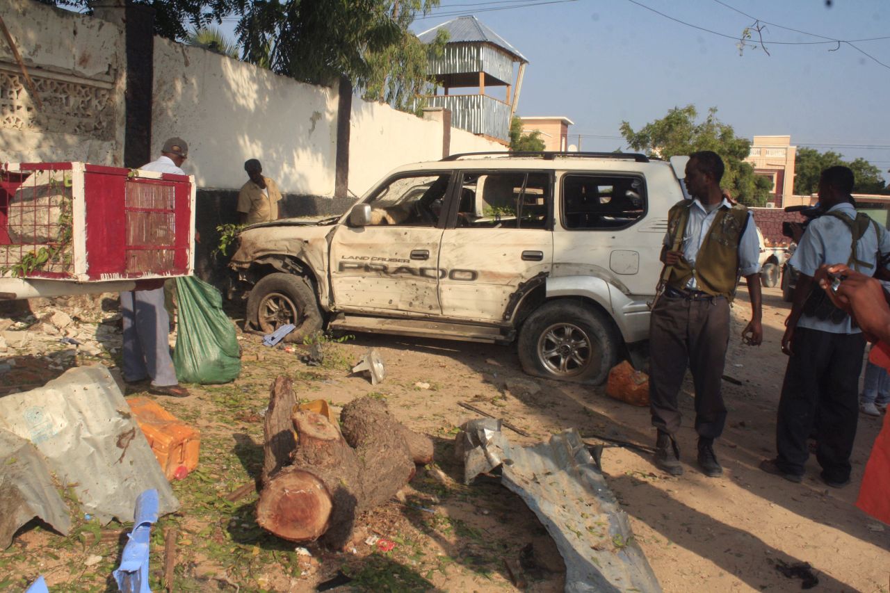 Despite the relatively peaceful business environment, insurgents still launch sporadic attacks. Jamal's restaurants have also been targeted. Pictured, Somali security forces stand near the debris left after two suicide bombers attacked one of "The Village" restaurants on November 3, 2012.
