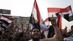 Muslim Brotherhood members and supporters of deposed president Mohamed Morsi shout slogans waving national flags during a rally outside Rabaa al-Adawiya mosque on July 15, 2013 in Cairo, Egypt. A top US official pressed Egypt's interim leaders for a return to elected government after the army ousted Morsi, whose supporters massed to rally for his return. AFP PHOTO/GIANLUIGI GUERCIA (Photo credit should read GIANLUIGI GUERCIA/AFP/Getty Images)