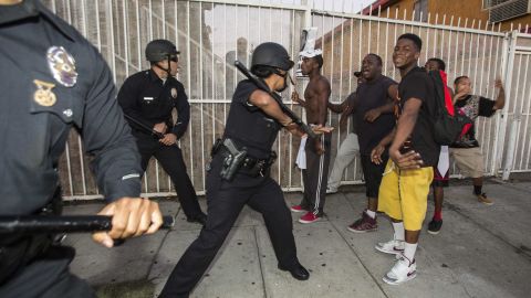 Protesters confront police officers on Monday, July 15, in Los Angeles.