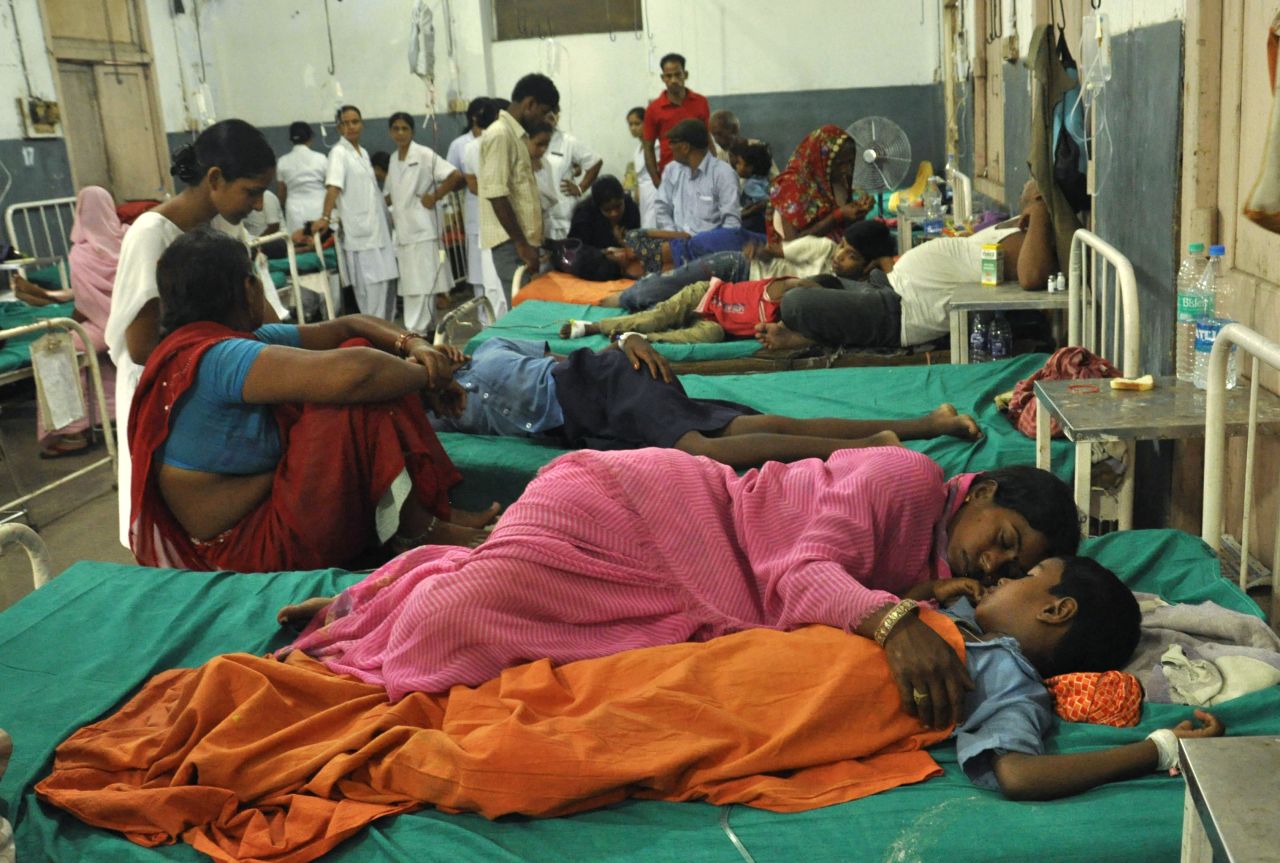 A woman rests with her child at a ward housing the poisoned schoolchildren at the Patna Medical College and Hospital, in the eastern Indian state of Bihar, Wednesday, July 17. At least 22 schoolchildren died in northeastern India after eating free school lunches that contained an insecticide commonly used in agriculture. Officials are investigating whether the poisoning was accidental or deliberate. 