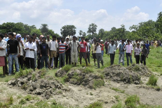 Villagers gather for a funeral for children who died from the poison.
