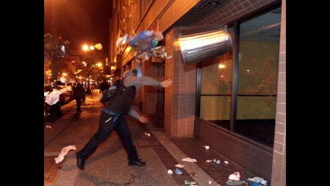 A man throws a trashcan during a protest in Oakland, California, on July 14.