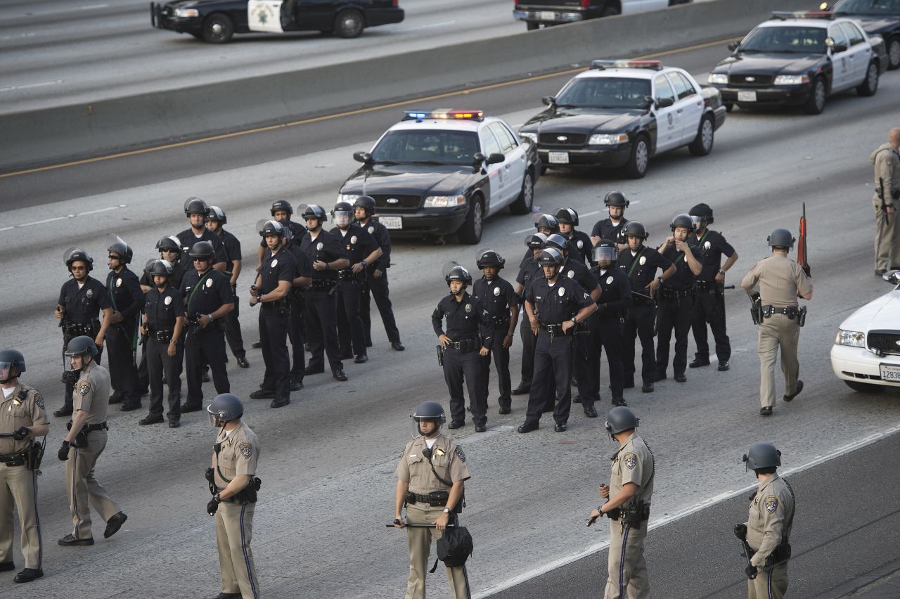 Police hold positions on I-10 in Los Angeles. Protesters walked onto the freeway, stopping traffic, on July 14.
