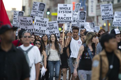 Protesters march through the streets of downtown Los Angeles, on Tuesday, July 16, during a demonstration of the George Zimmerman trial.