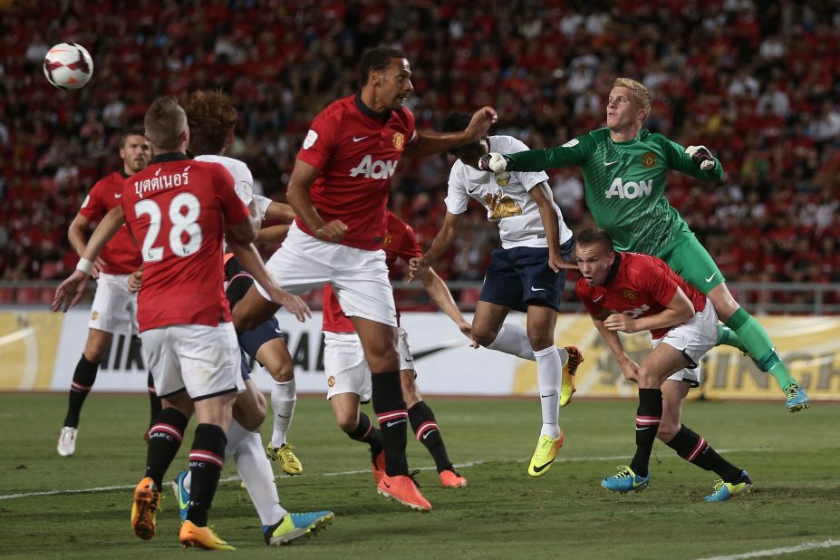 Players scramble as Manchester United's Ben Amos punches the ball away during a friendly between Singha All Star XI and Manchester United in Bangkok, Thailand. Alex Buttner picked up a hamstring strain in the friendly.