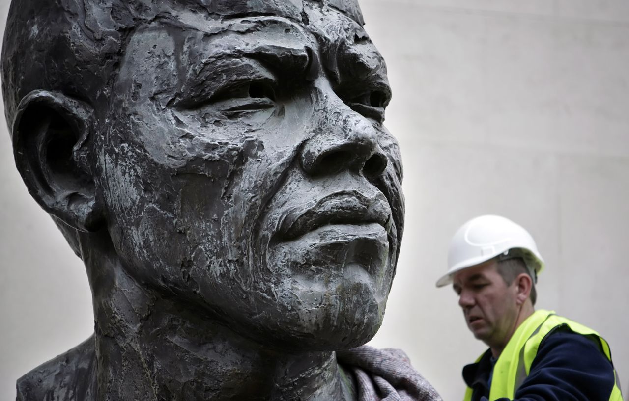 <strong>ENGLAND: </strong>A six-foot bronze sculpture of Mandela is lifted onto a platform in front of the Royal Festival Hall in central London. Cast in bronze, the sculpture was originally unveiled in 1985, five years before Mandela's release from prison.
