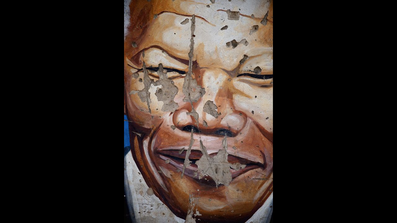 <strong>SOUTH AFRICA: </strong>A mural depicts Mandela near the Regina Mundi Catholic Church in the Soweto Township in Johannesburg. The church played a central role in the anti-apartheid struggle, opening its doors to shelter activists.