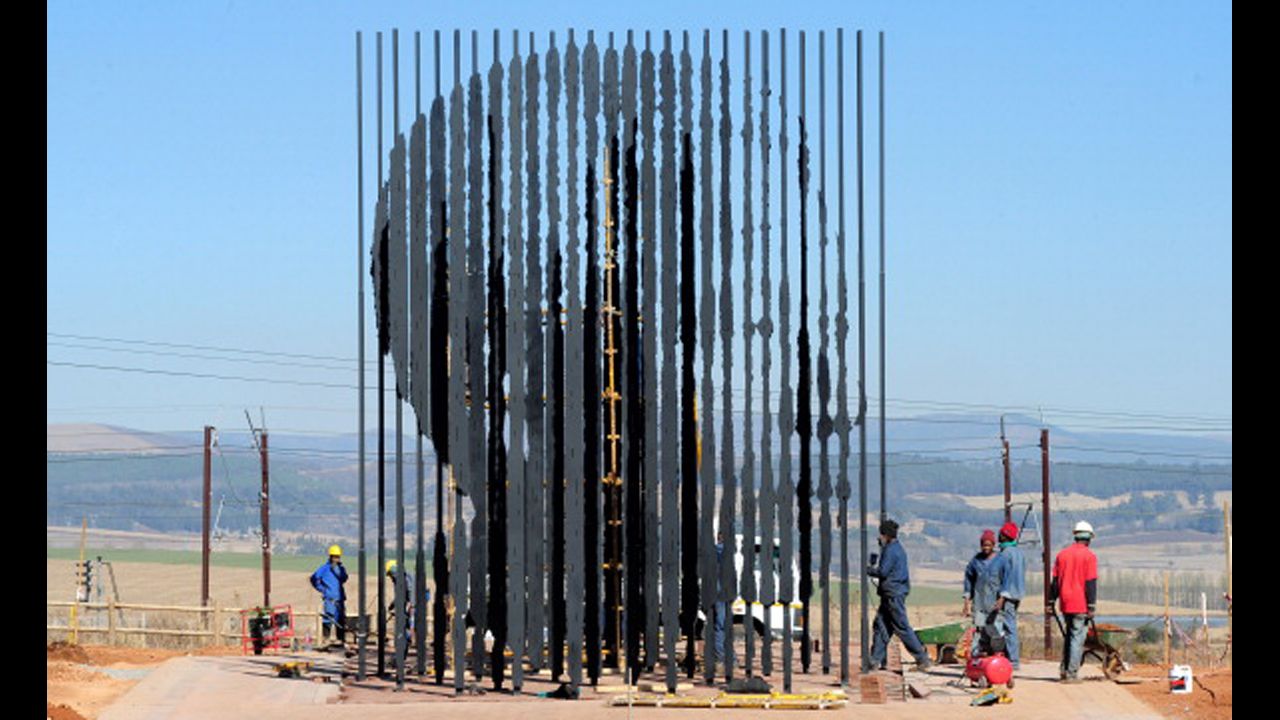 <strong>SOUTH AFRICA:</strong> Construction workers add the final touches to a Mandela statue outside Howick, South Africa. The monument will form part of the museum that was opened in the Midlands Meander at the spot where Mandela was arrested on August 5, 1962.