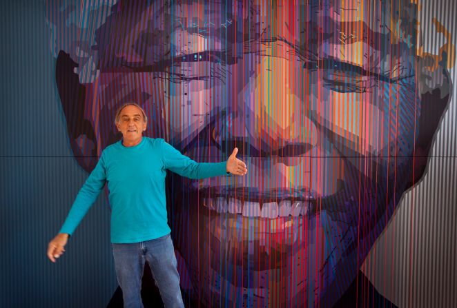 <strong>SOUTH AFRICA: </strong>South African artist Paul Blomkamp stands in front of the giant acrylic-on-canvas painting he made of Mandela at his studio in Johannesburg. He said he was drawn to Mandela because of his "exceptional energy."