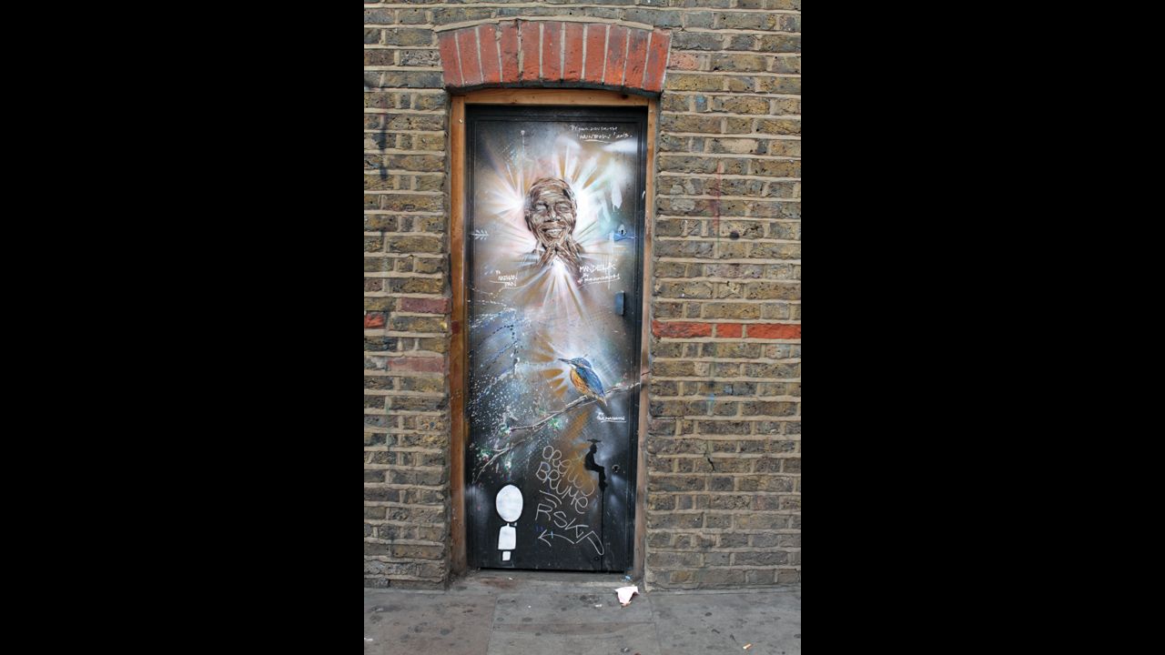 <strong>ENGLAND: </strong>Graffiti of Mandela by Paul Don Smith is seen on a door in East London. 