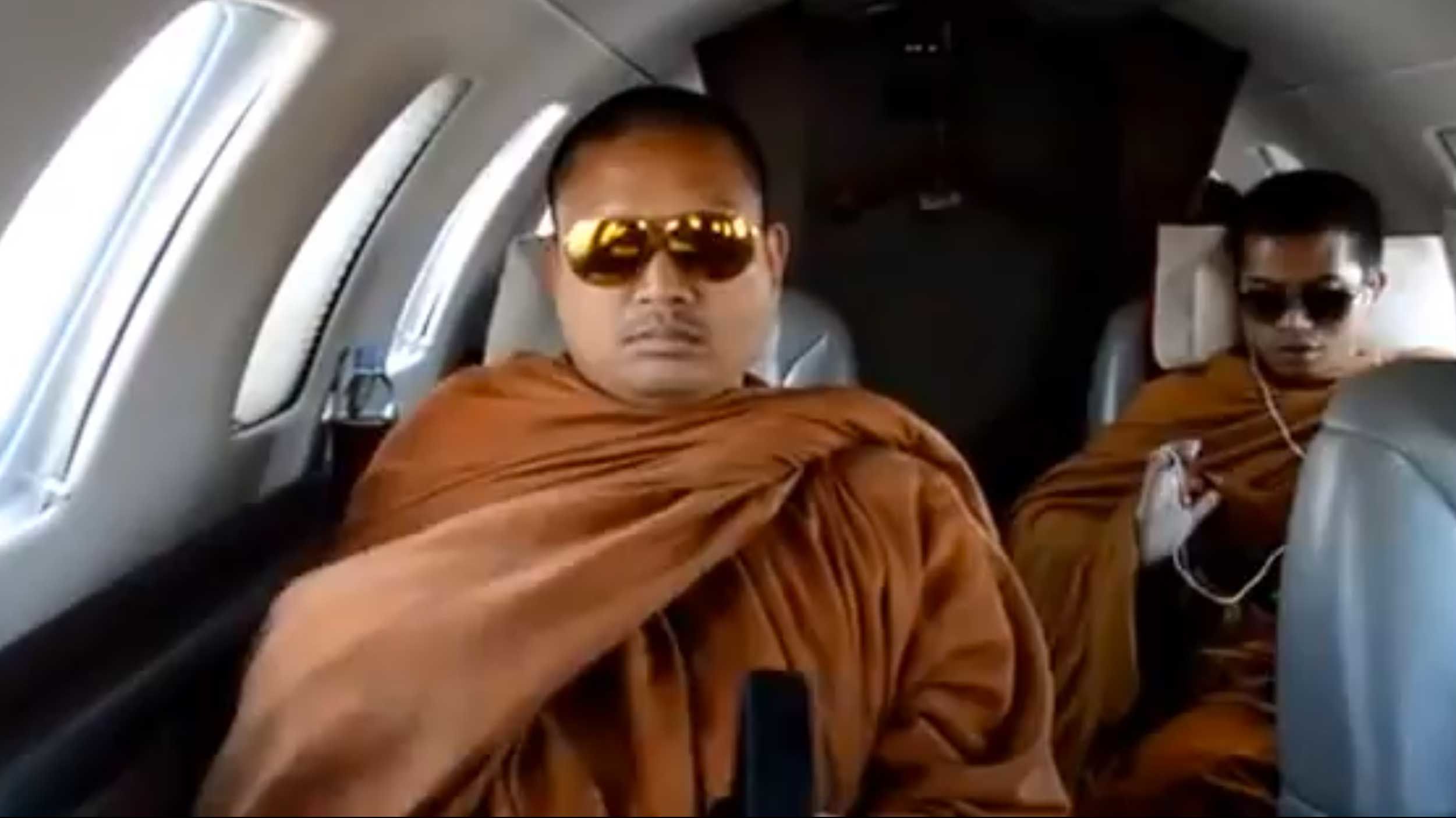 This still image taken from amateur footage posted on YouTube purportedly shows Luang Pu Nenkham (L) on a private jet.