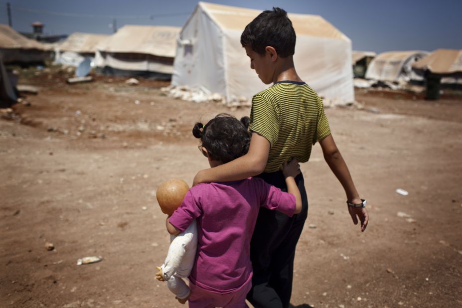 Syrian refugee children walk in the Bab al-Salam refugee camp in Syria's northern city of Azaz in July 2013.