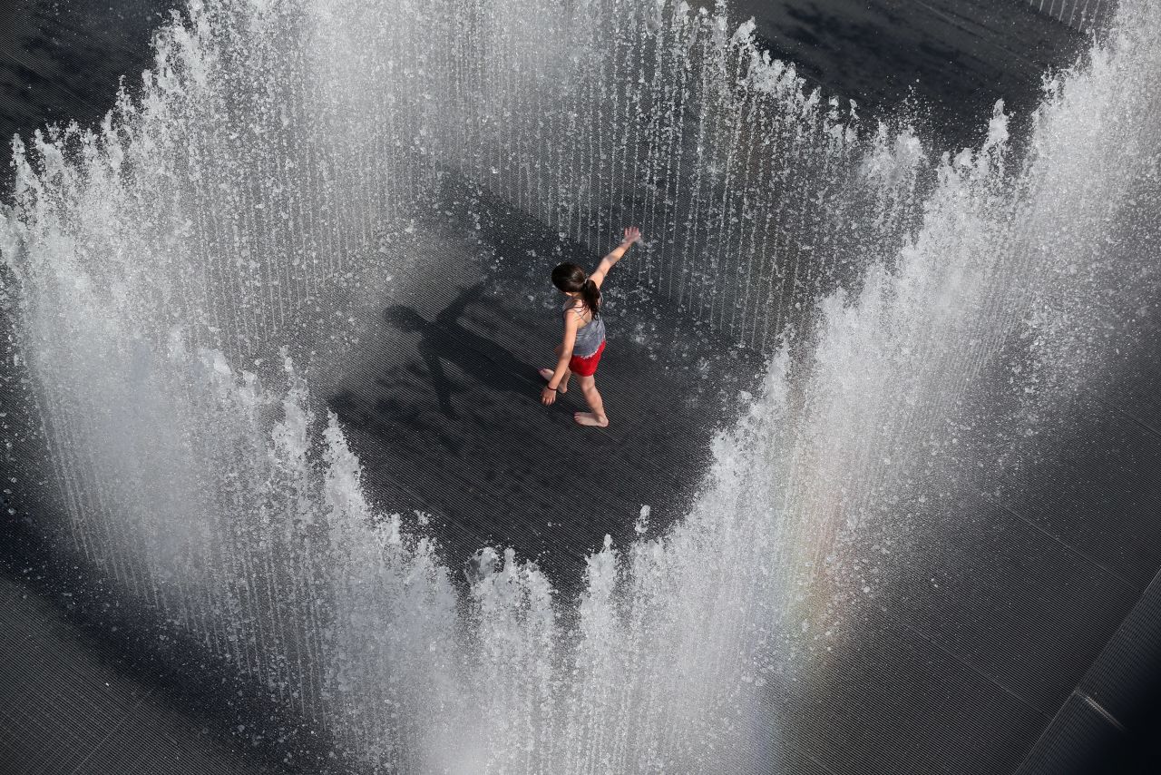 A girl plays in the fountain called "Appearing Rooms," by Danish artist Jeppe Hein, in central London on July 18. The United Kingdom is experiencing a second week of heatwave conditions.