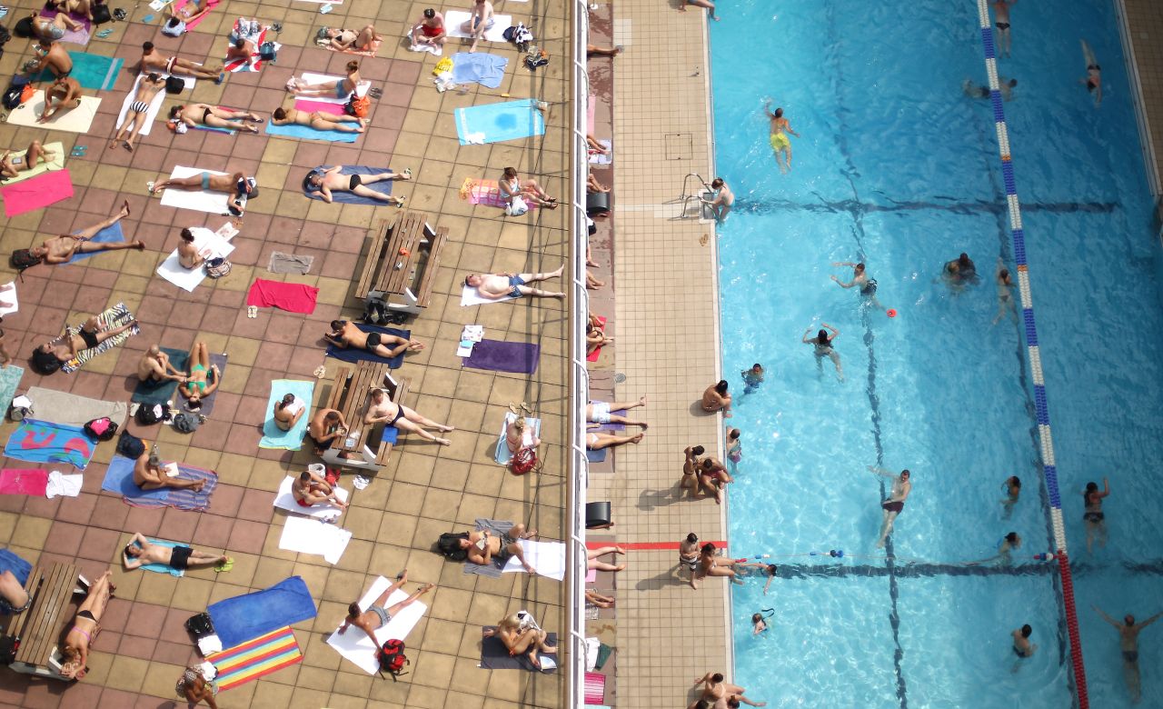 Swimmers enjoy the sunshine at an outdoor pool in central London on Wednesday, July 17. 