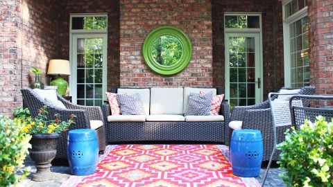 <a href="http://ireport.cnn.com/docs/DOC-1005402">Emily Clark</a> livened up her patio with a colorful outdoor rug and spray painting a mirror and two garden stools.