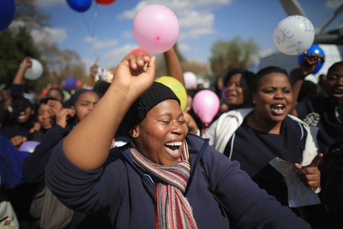 JULY 18 - PRETORIA, SOUTH AFRICA: People gather in front of the Pretoria hospital where Nelson Mandela is being treated, as the world celebrates the former South Africa's <a href="http://cnn.com/2013/07/18/world/africa/south-africa-mandela/index.html?hpt=iaf_c1">president's 95th birthday</a>. Mandela has been in <a href="http://cnn.com/2013/06/26/world/africa/mandela-hospital-messages/index.html?iid=article_sidebar">the hospital since June 8</a>, suffering from a lung infection.