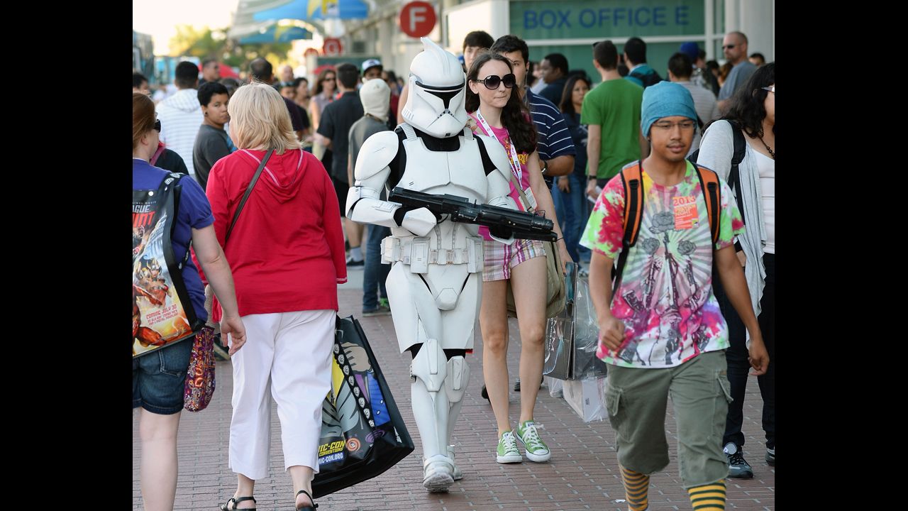 Myke Soler walks outside the San Diego Convention Center dressed as a "Star Wars" stormtrooper with his wife during Comic-Con International 2013 on Wednesday, July 17, in San Diego, California.  Started in 1970, the event is estimated to bring well over 100,000 attendees.