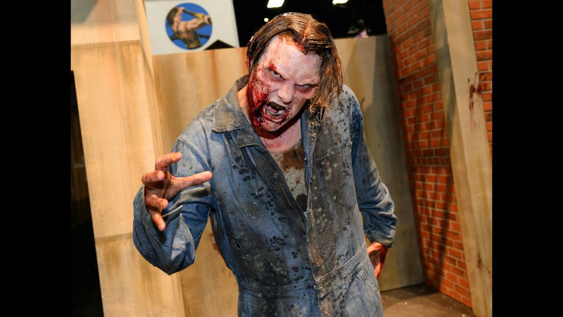 A zombie character poses at "The Walking Dead" booth.