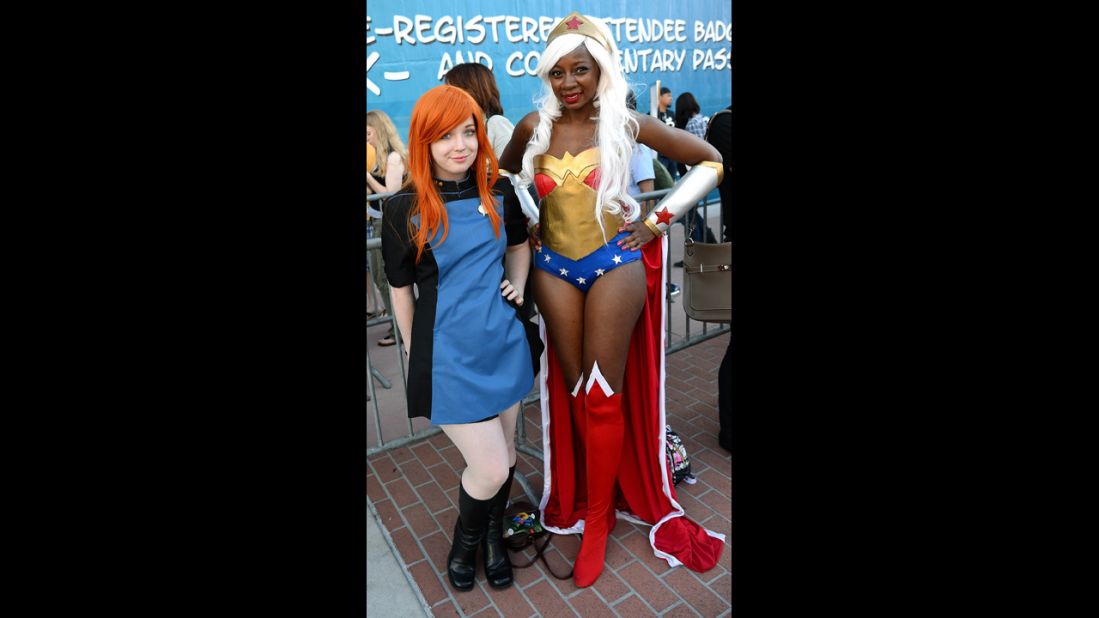 Rachel Elsten, left, dressed in a Star Trek uniform and Chaka Cumberbatch, dressed as Wonder Woman, pose outside the convention center.