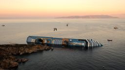 A bird flies overhead the Costa Concordia on January 18, 2012. Rescue operations were suspended as the ship slowly sank further into the sea.