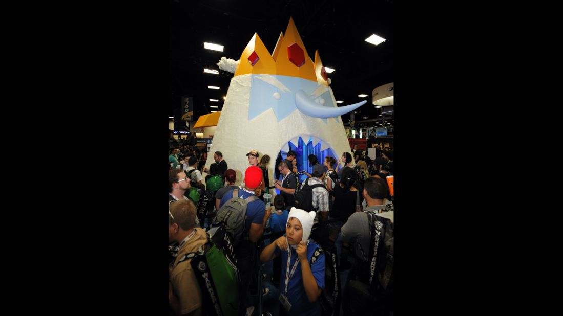 Fans wait to walk through a giant display of Ice King character from "Adventure Time" at the Cartoon Network booth during the Preview Night event.