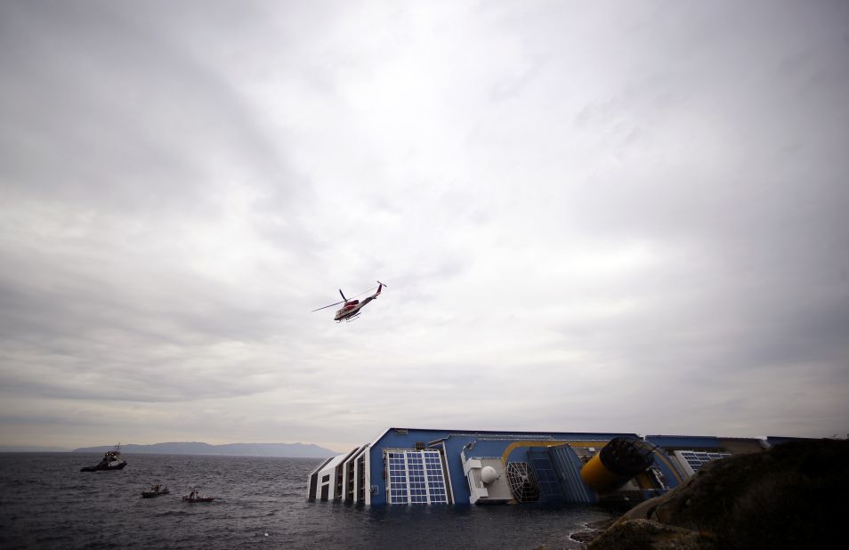 Rescuers search the waters near the stricken ship on January 16, 2012.