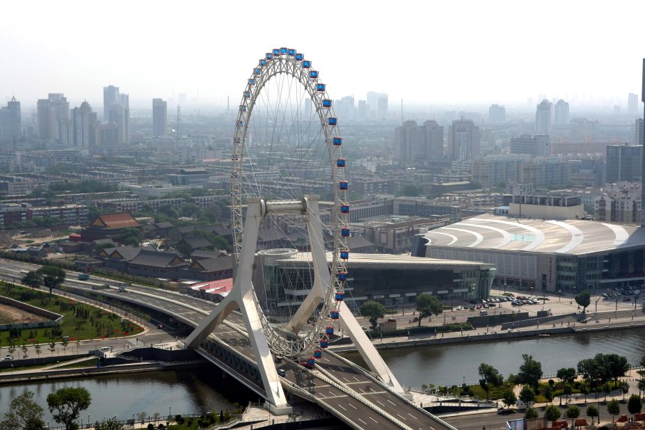 The Tianjin Eye, in its namesake city in northeastern China near Beijing, was built on a bridge across the Hai River. The wheel can hold 770 passengers in 48 capsules. Riders can get amazing views of the city and the cars on the highway below them during the 30-minute rotation.<br />