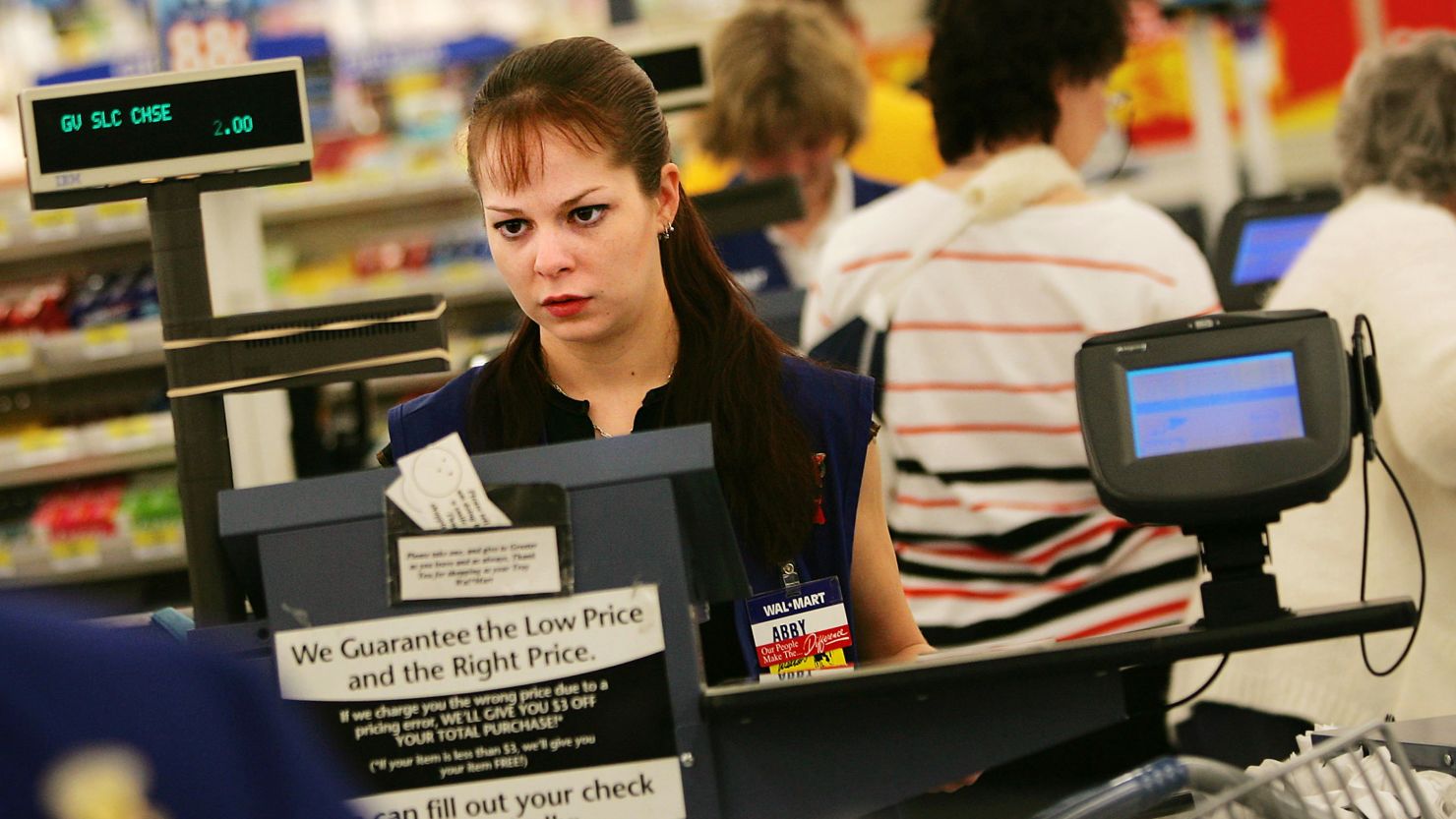A cashier works the register at a Wal-Mart Supercenter. Nancy Pelosi and Rosa DeLauro say women and their families are struggling financially.
