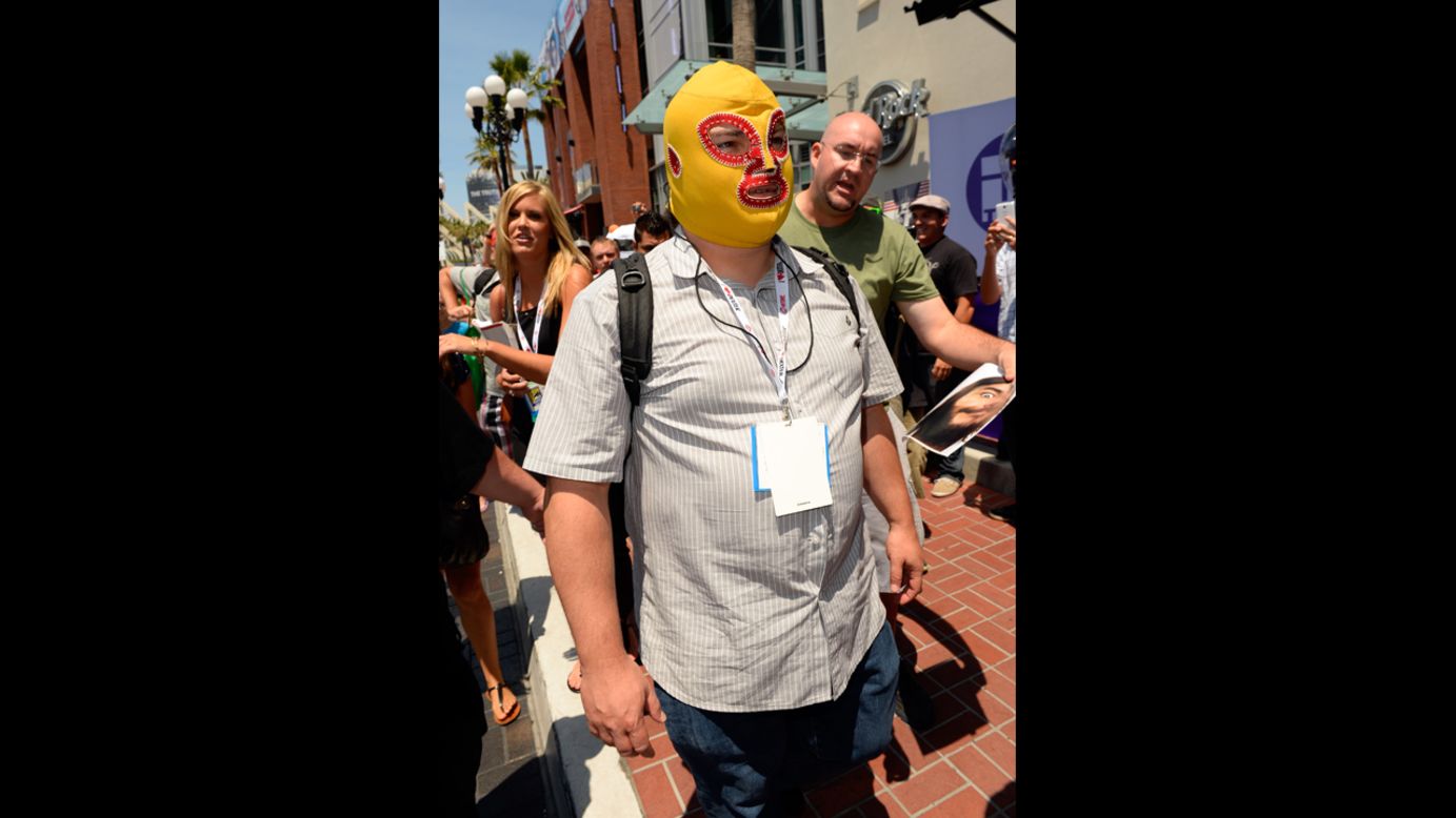 A masked Jack Black walks down the street as fans ask for his autograph on July 18.