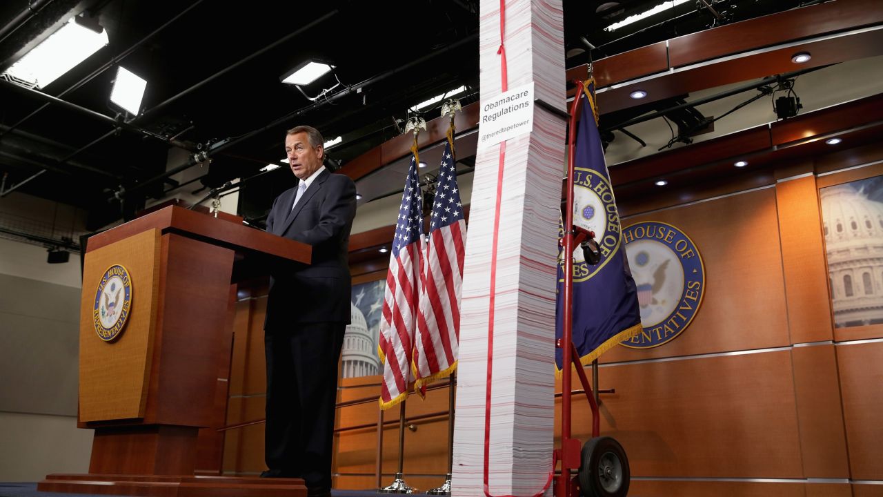 Speaker John Boehner stands next to a printed version of the Affordable Care Act on May 16 in Washington.