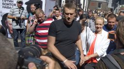 Russia's top opposition leader Alexei Navalny holds the hand of his wife Julia after leaving the courtroom in Kirov on July 19, 2013. A Russian court on Friday unexpectedly freed protest leader Alexei Navalny pending his appeal against a five-year sentence on embezzlement charges, after his jailing prompted thousands to take to the streets in protest. The judge in the northern city of Kirov ruled that keeping President Vladimir Putin's top opponent in custody would deprive him of his right to stand in mayoral elections in Moscow on September 8. AFP PHOTO/SERGEI BROVKOSERGEI BROVKO/AFP/Getty Images
