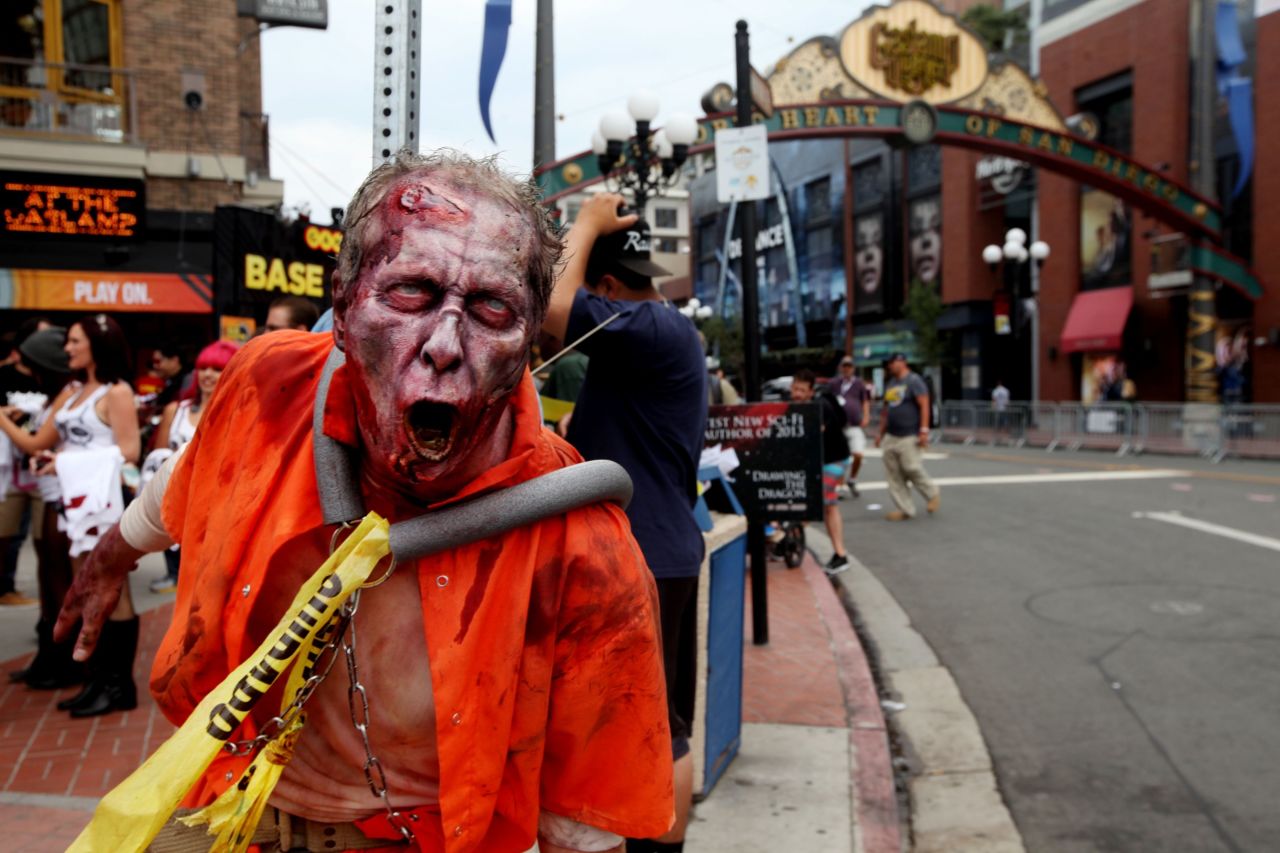 A zombie greets people as along 5th Avenue on July 19, in San Diego's Gaslamp Quarter during the convention.