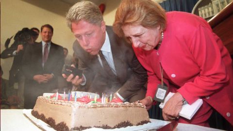 President Bill Clinton and Thomas blow out candles during a surprise 75th birthday party for Thomas in the briefing room at the White House on August 4, 1995.