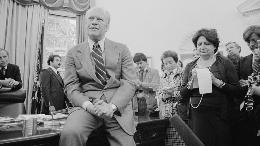 Thomas takes notes as President Gerald Ford speaks to reporters in Washington on September 30, 1976.